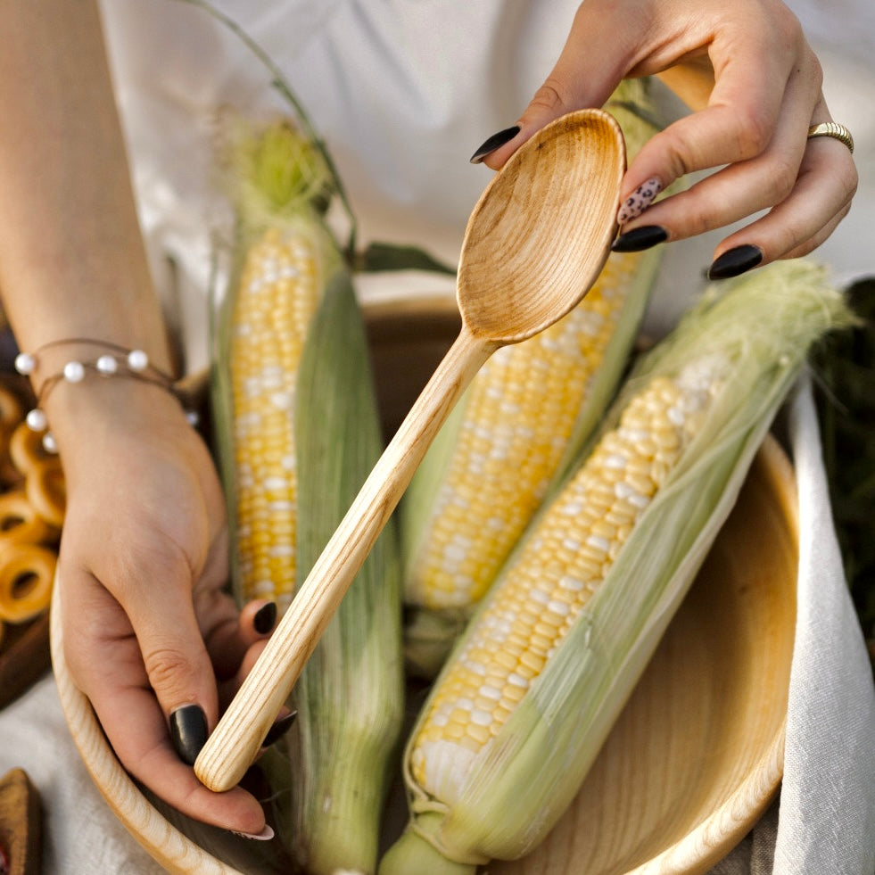 Handcrafted wooden spoon made of oak and ash for kitchen use