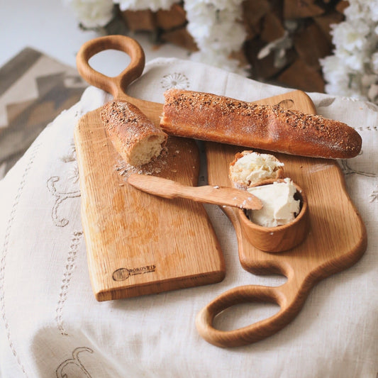 Two oak boards used for cutting or serving cheese and fruit