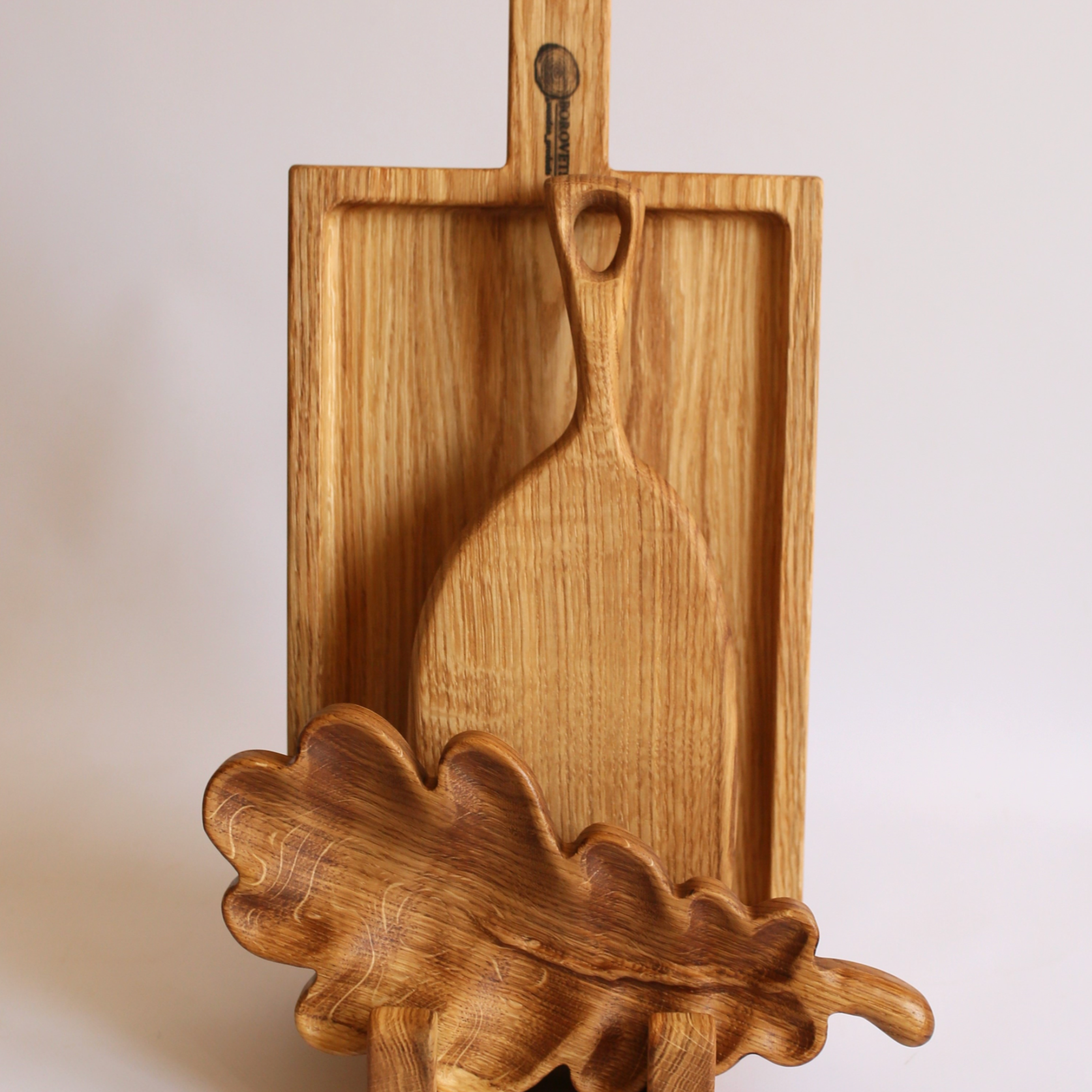 Rustic oak wooden serving boards in festive gift packaging, perfect for holiday celebrations.