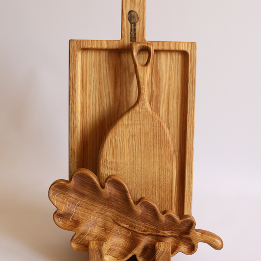 Rustic oak wooden serving boards in festive gift packaging, perfect for holiday celebrations.
