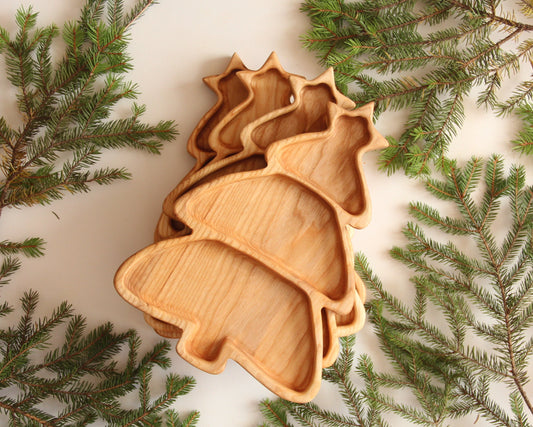 Christmas tree wooden serving plate with cookies on a holiday table