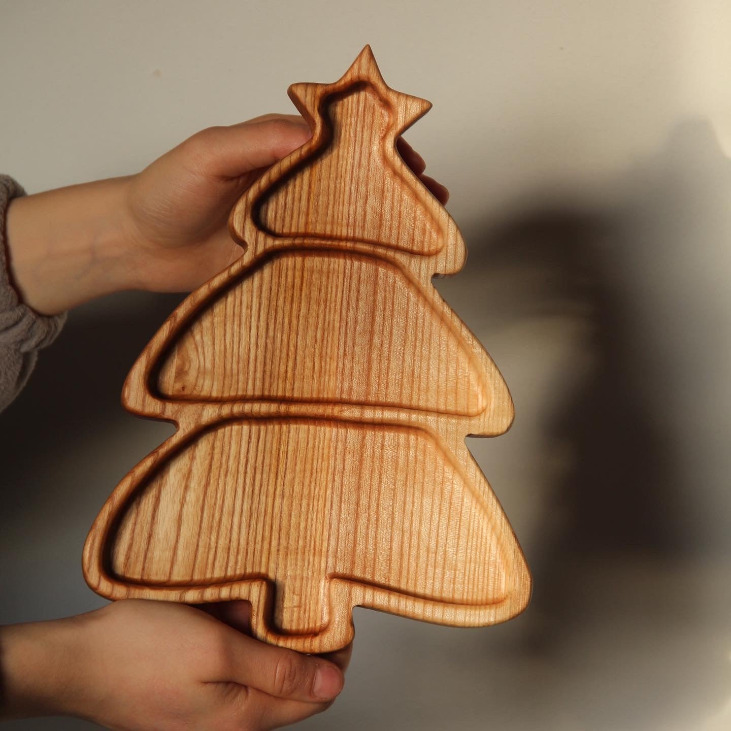 Engraved wooden Christmas tree platter prepared for holiday snacks