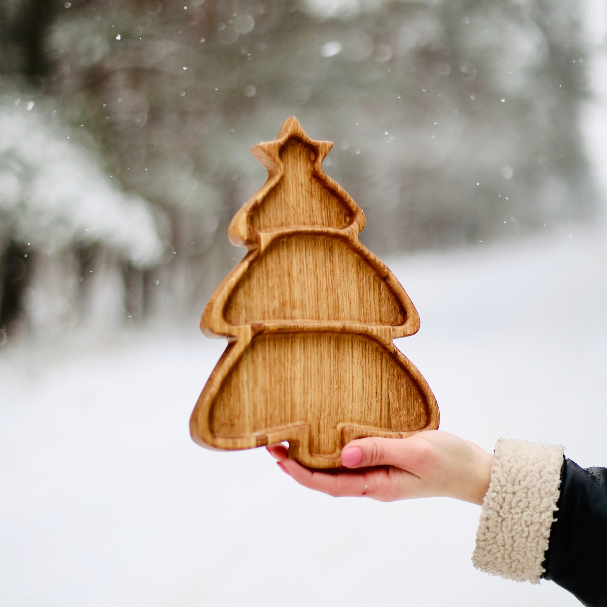 Christmas tree serving plate son the snowy winter background