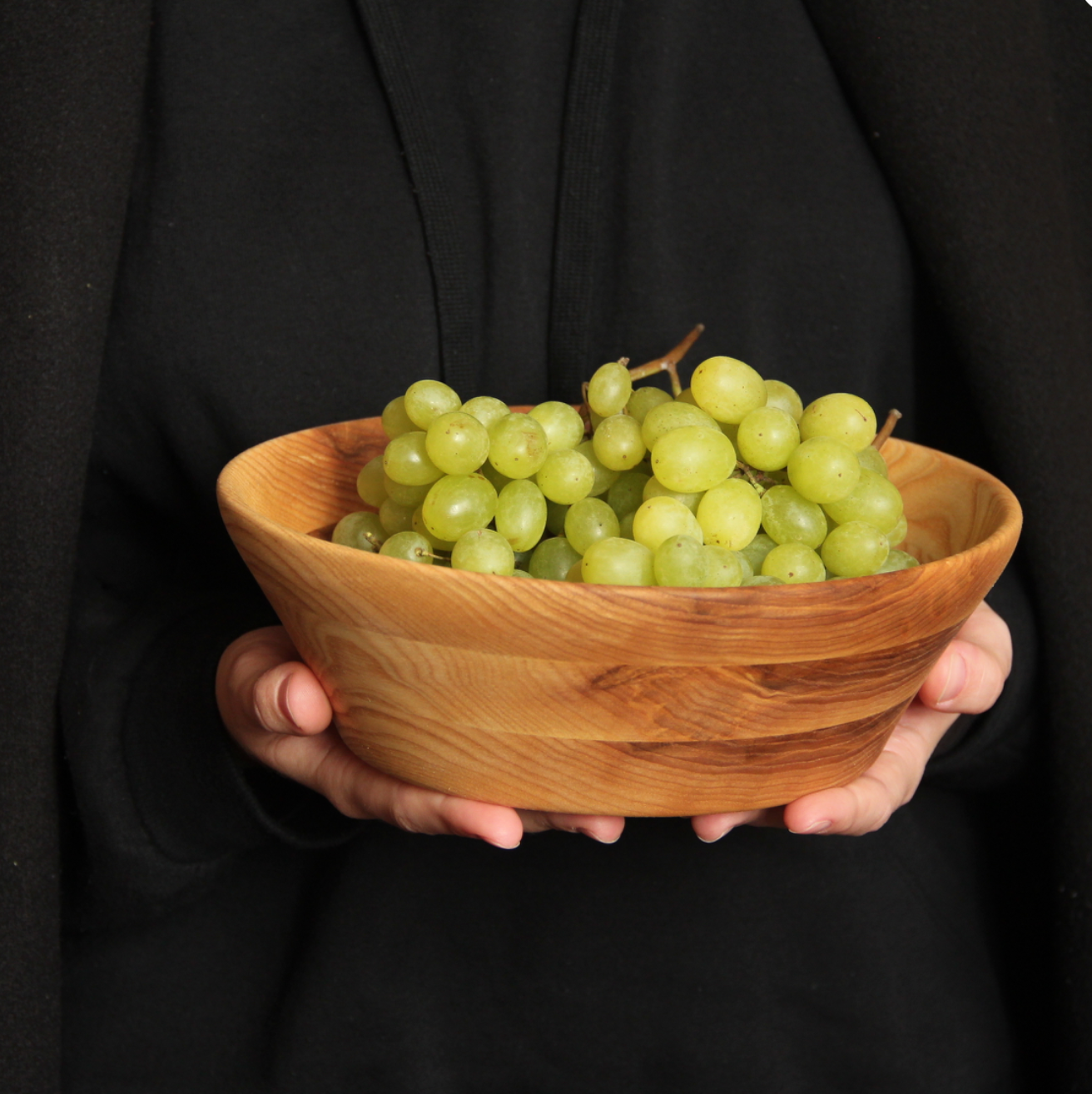 Deep ash wood salad bowl filled with fresh fruits
