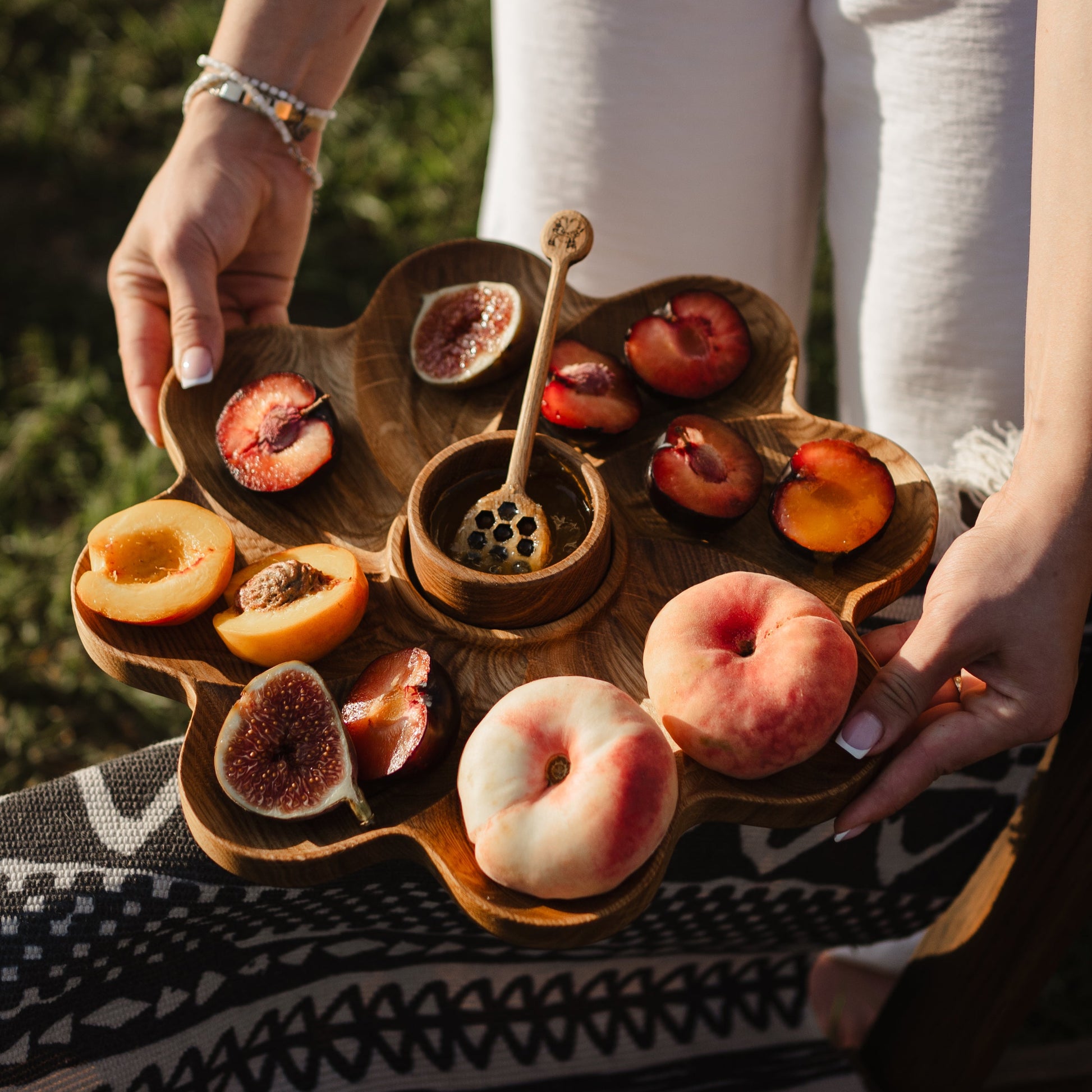 Rustic appetizer board set with a mini bowl filled with honey