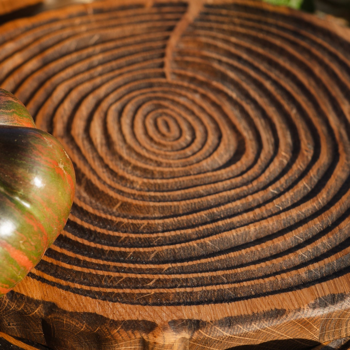 Close up of relief surface on round oak cutting board