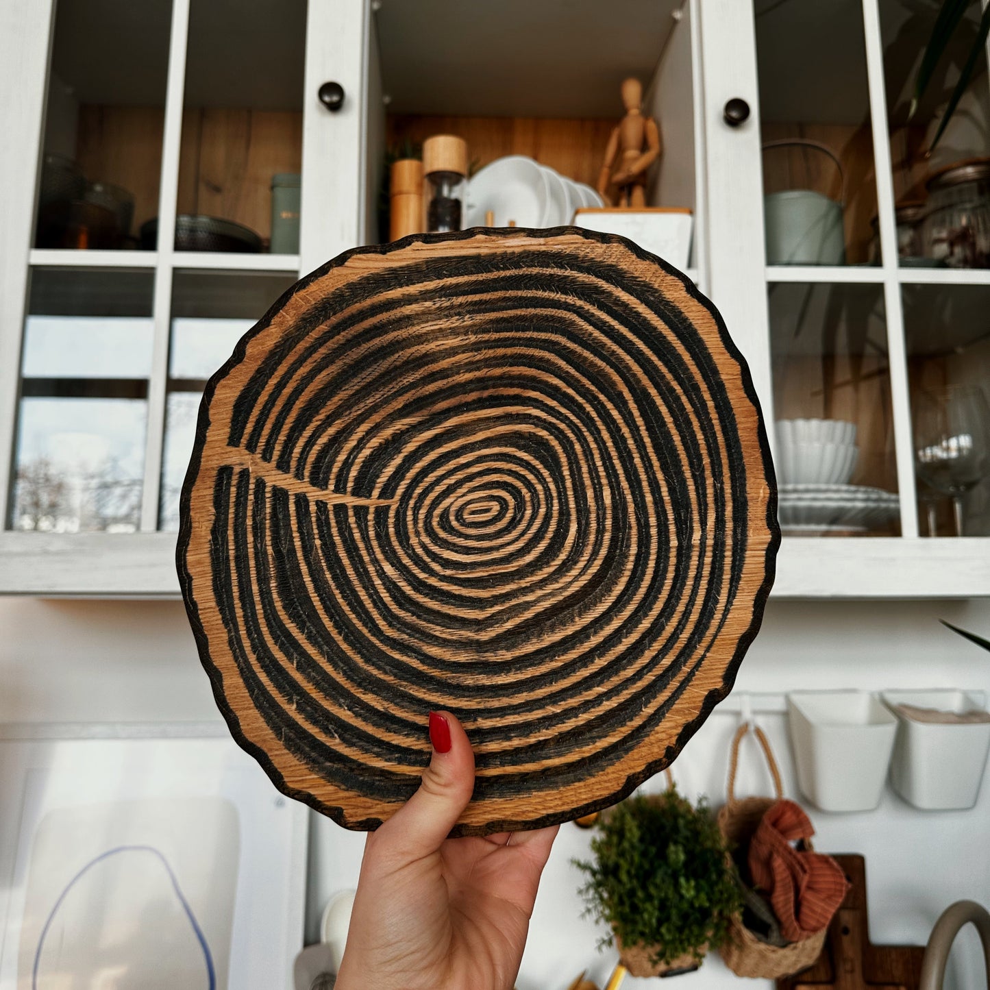 Handmade wooden round plate with relief surface, perfect for rustic kitchens