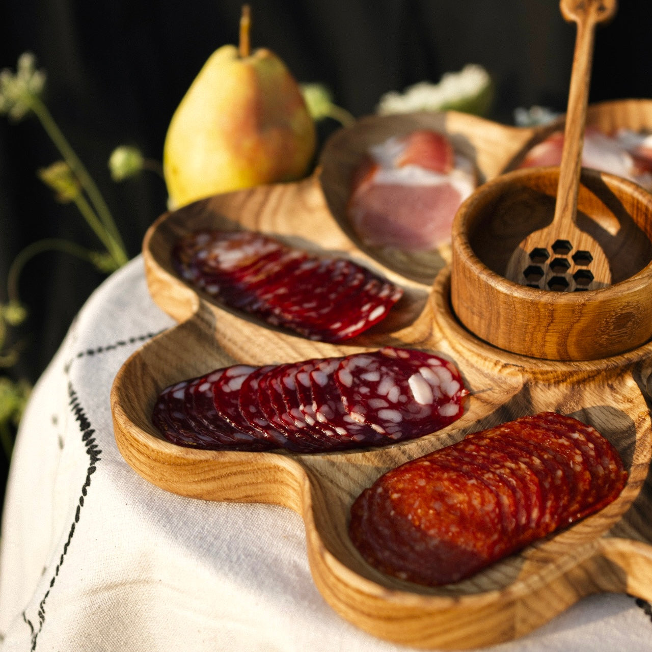 Top-down view of summer snack plate set with natural oak grain