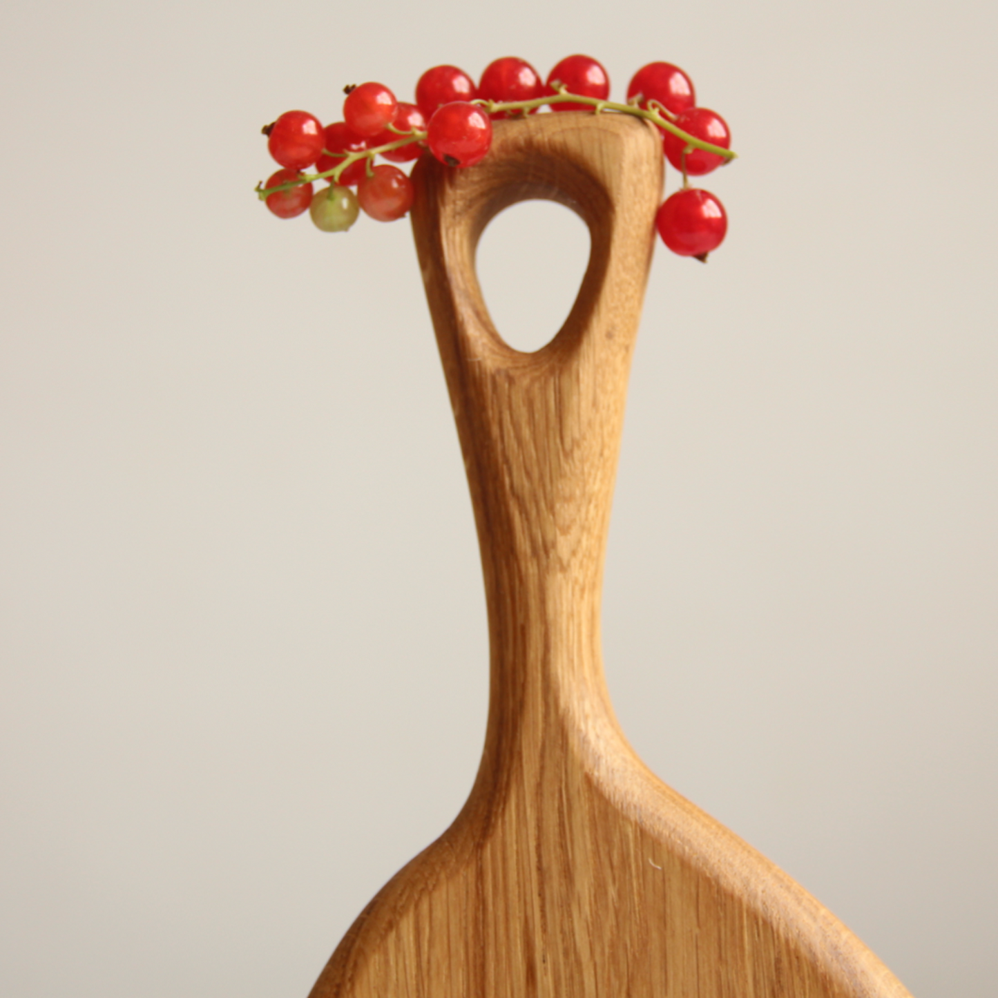 Oval wooden serving board styled with Christmas decorations