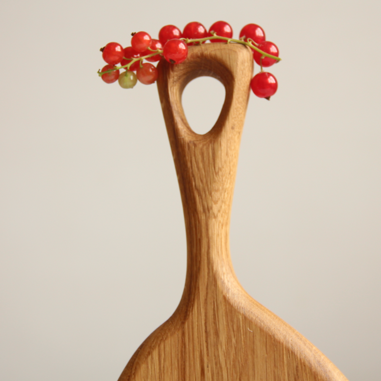 Oval wooden serving board styled with Christmas decorations