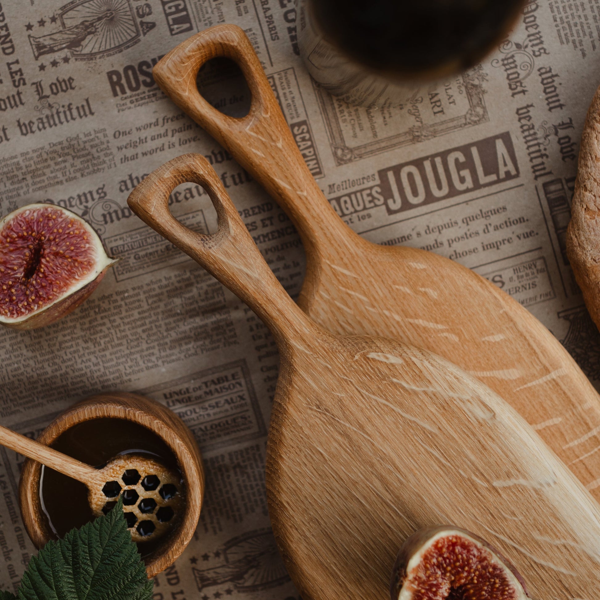 Person holding oval oak board in a modern kitchen