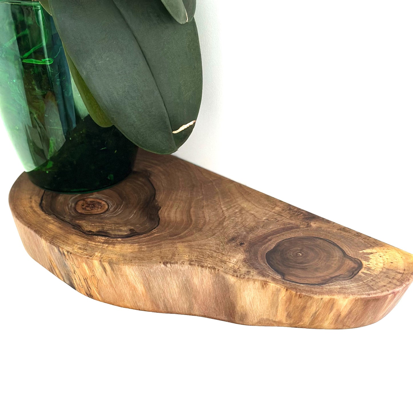 Rustic walnut shelf with natural wood grain and organic shape