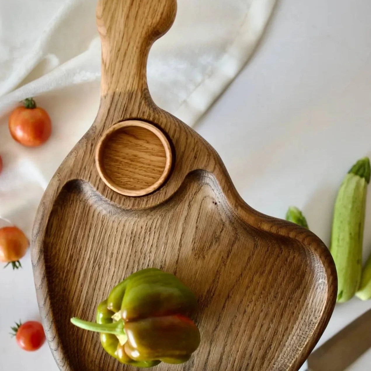 Rustic wooden appetizer tray with sauce bowl, perfect for snacks or cheese
