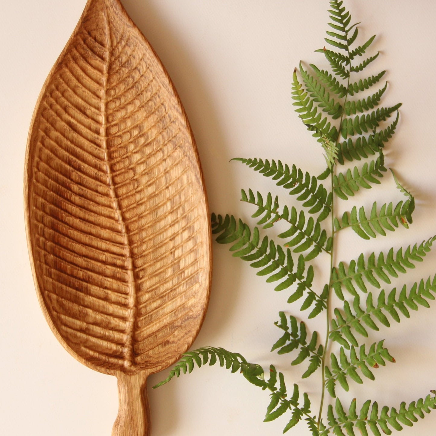 Rustic wooden snack tray with leaf design for serving treats and small bites
