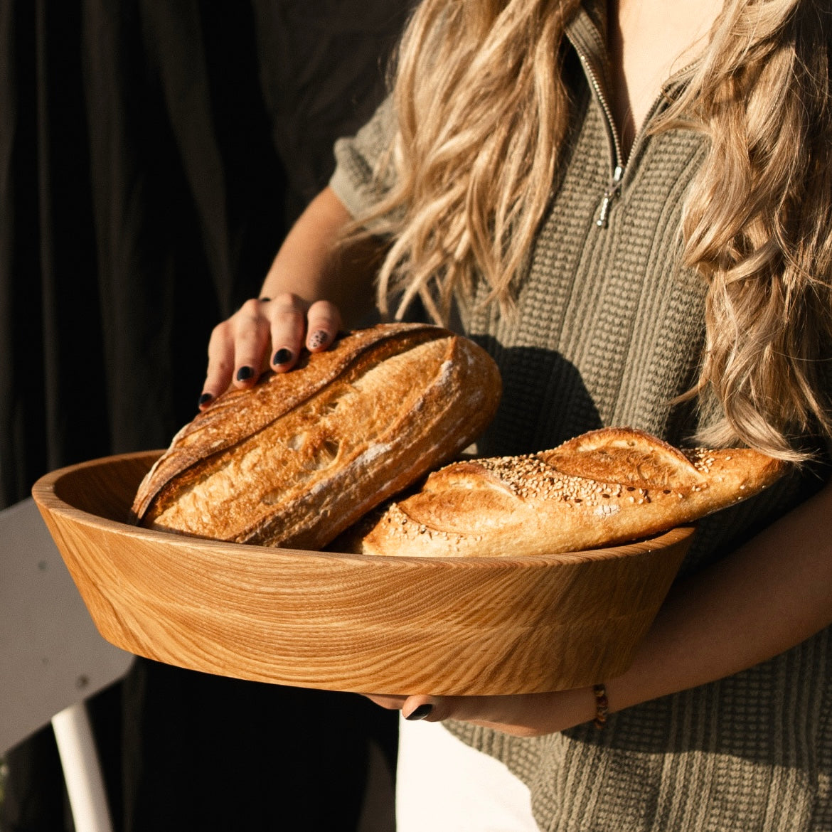 Rustic wooden platter used for bread fruits or snacks