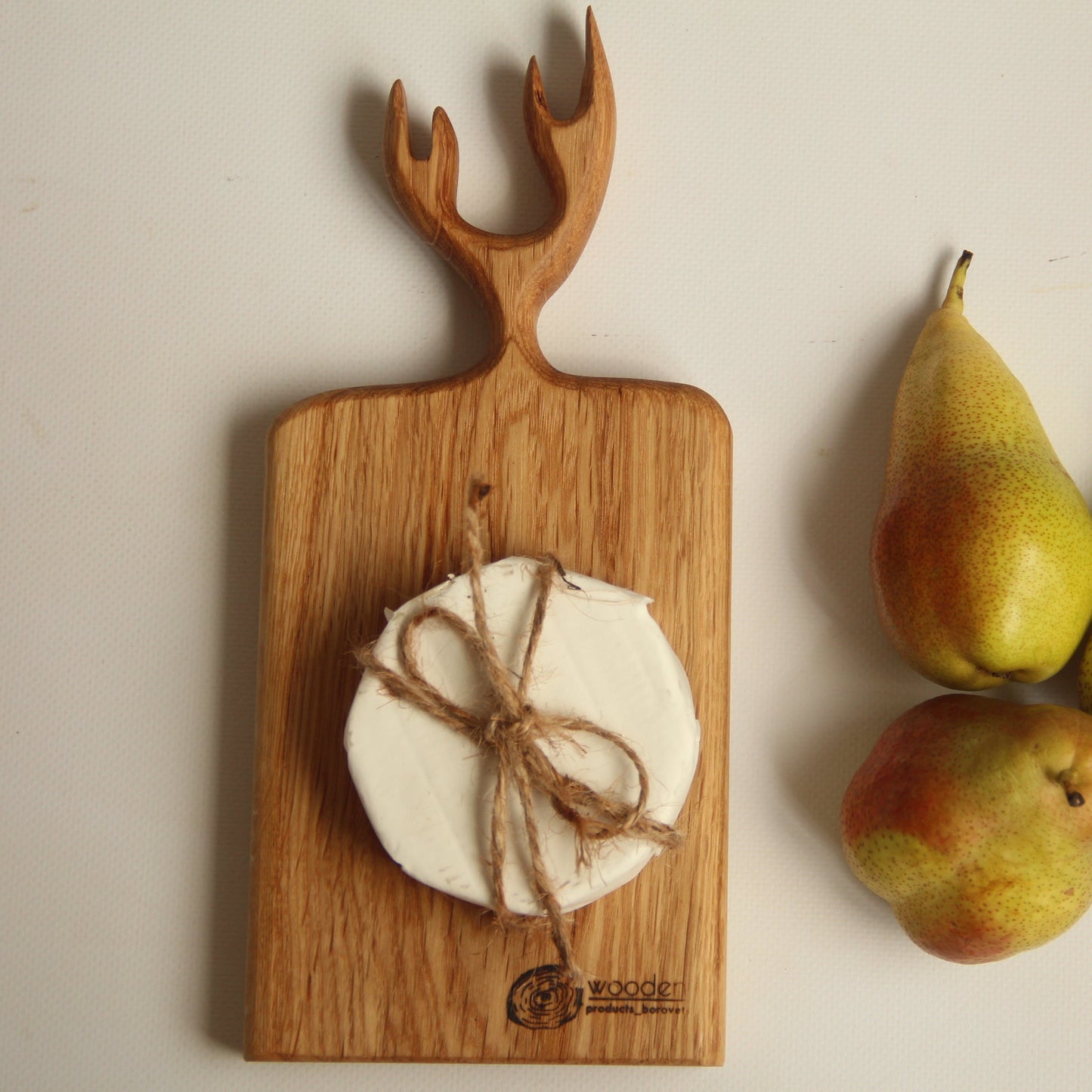 Rustic wooden charcuterie board with deer horn handle, ideal kitchen gift
